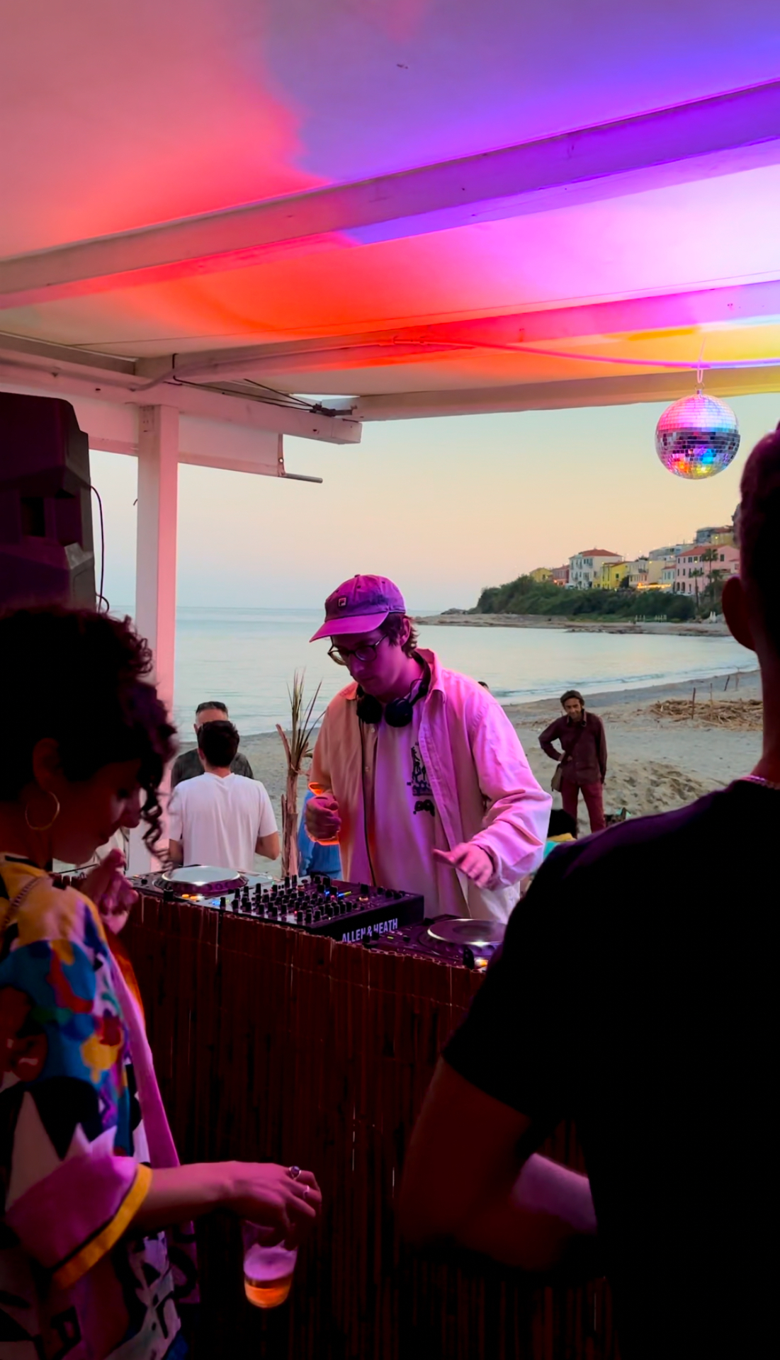 DJ at a beach party at sunset