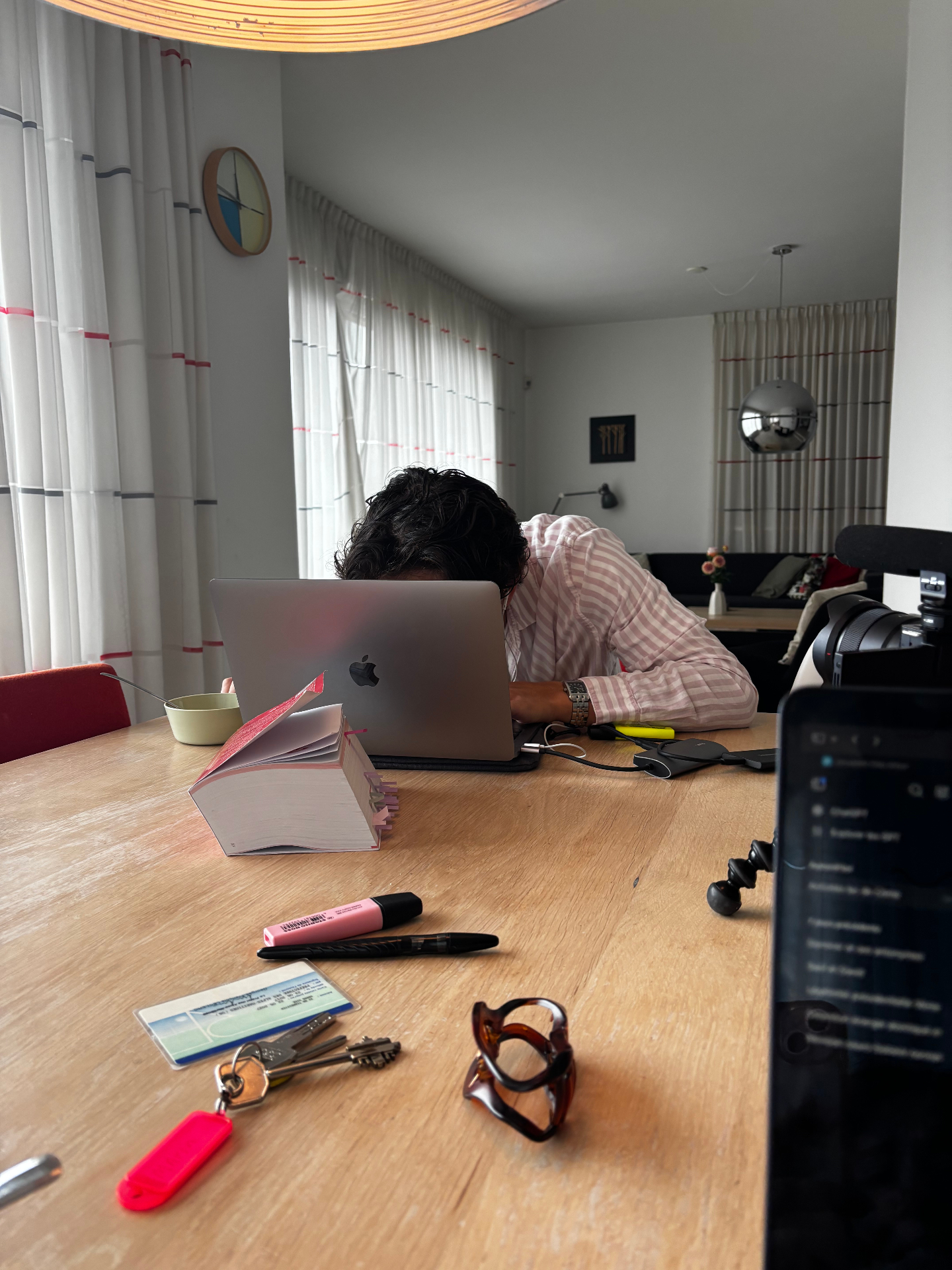 Person working on laptop at wooden desk